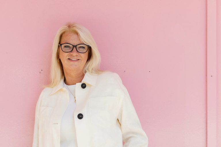 head shot against pink wall