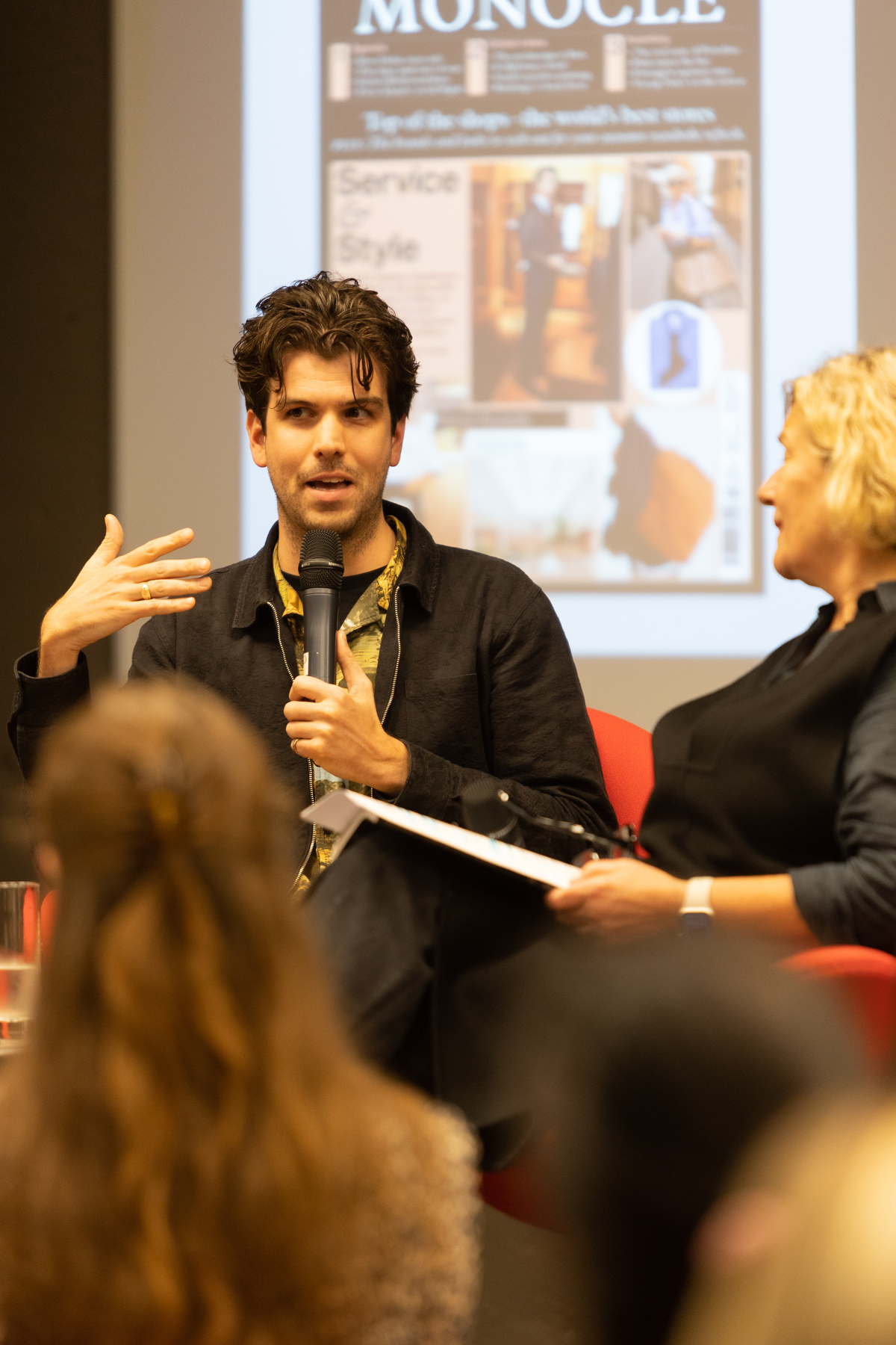 photograph of speaker at event in London.
