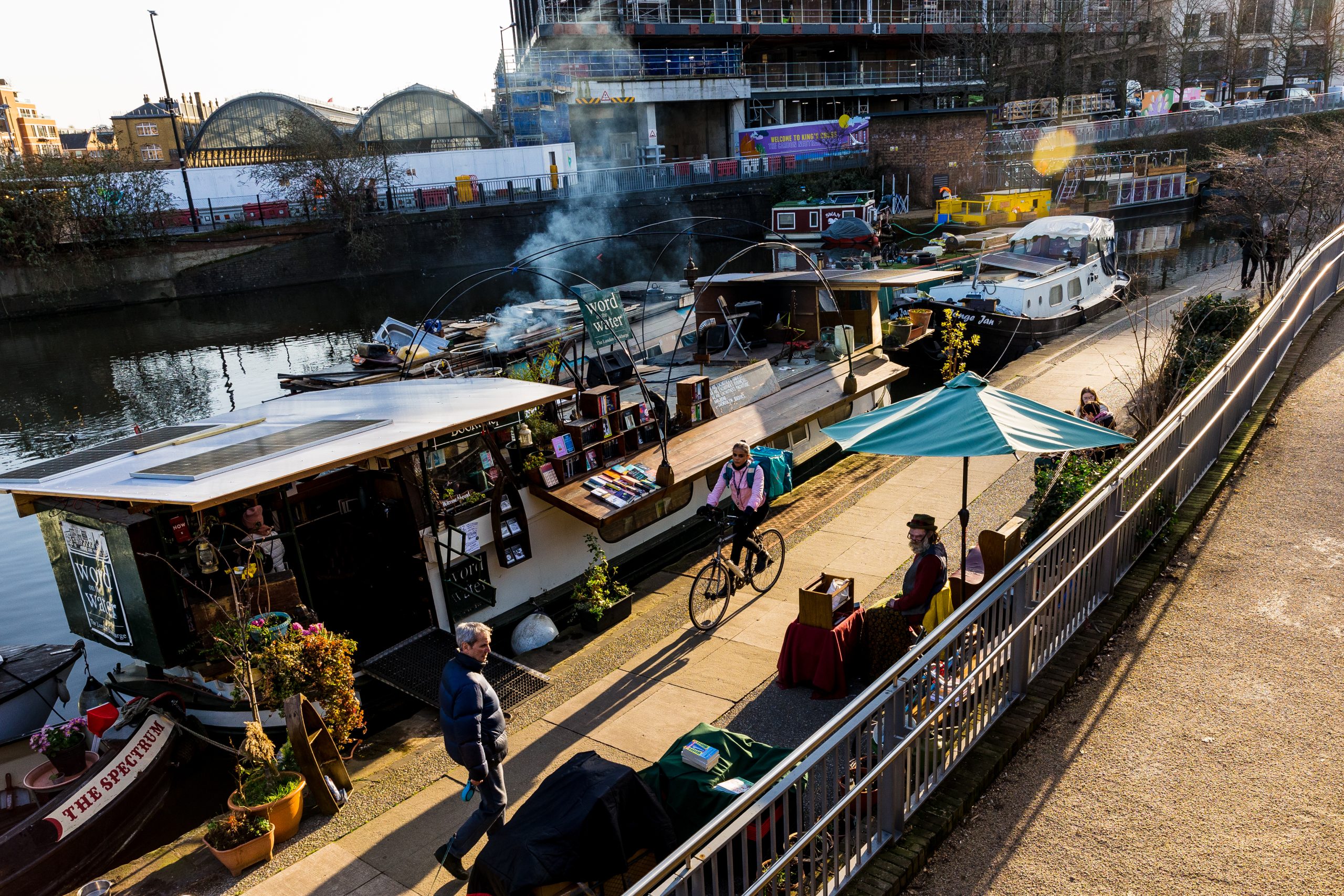 image of cyclist at dusk riding near canal at Kings Cross
